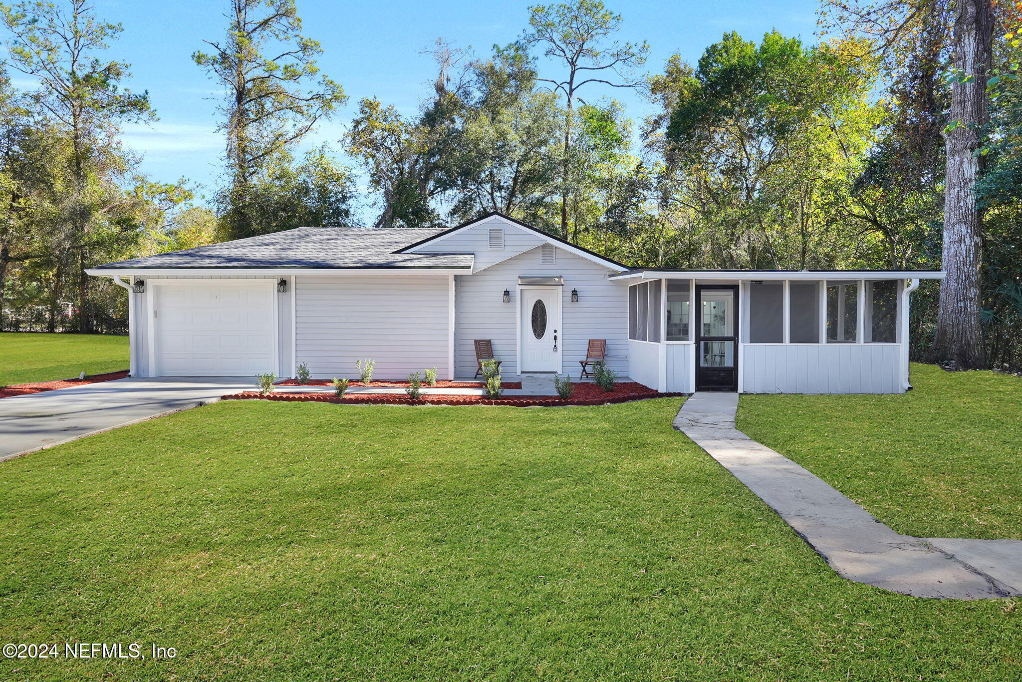 a front view of house with yard and green space