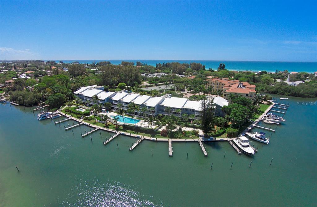 an aerial view of lake residential houses with outdoor space and swimming pool