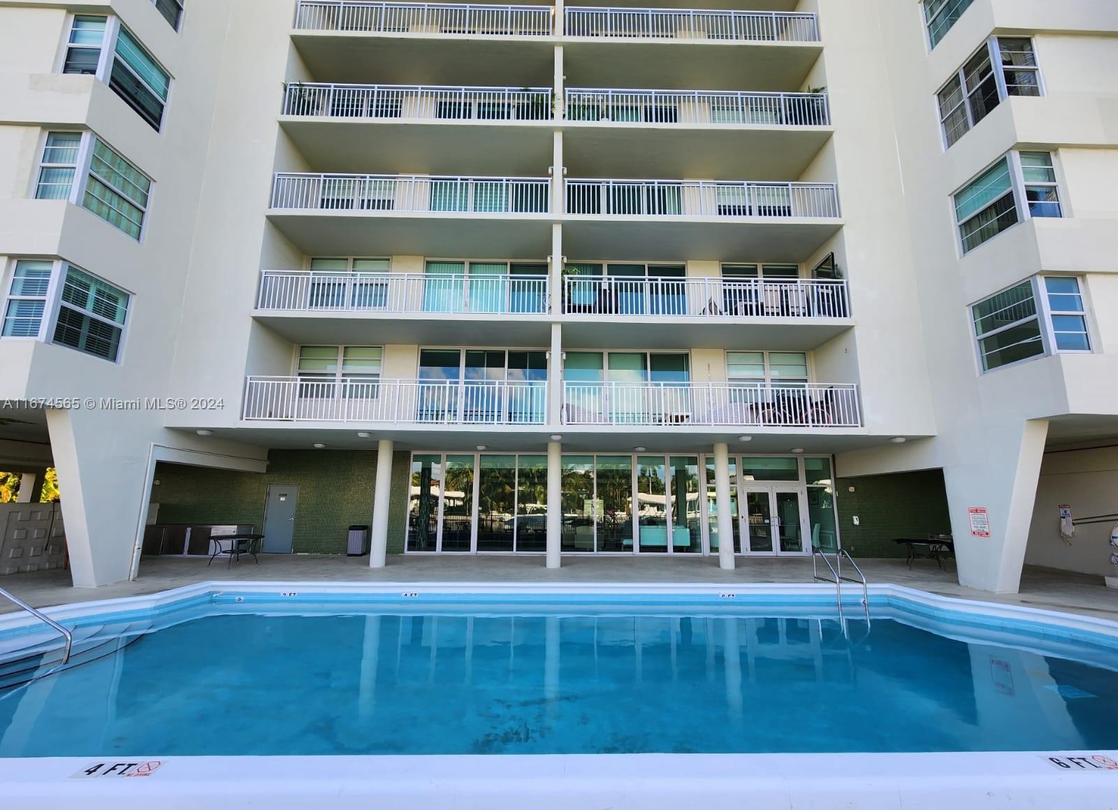 a view of an apartment with a floor to ceiling window and a fireplace