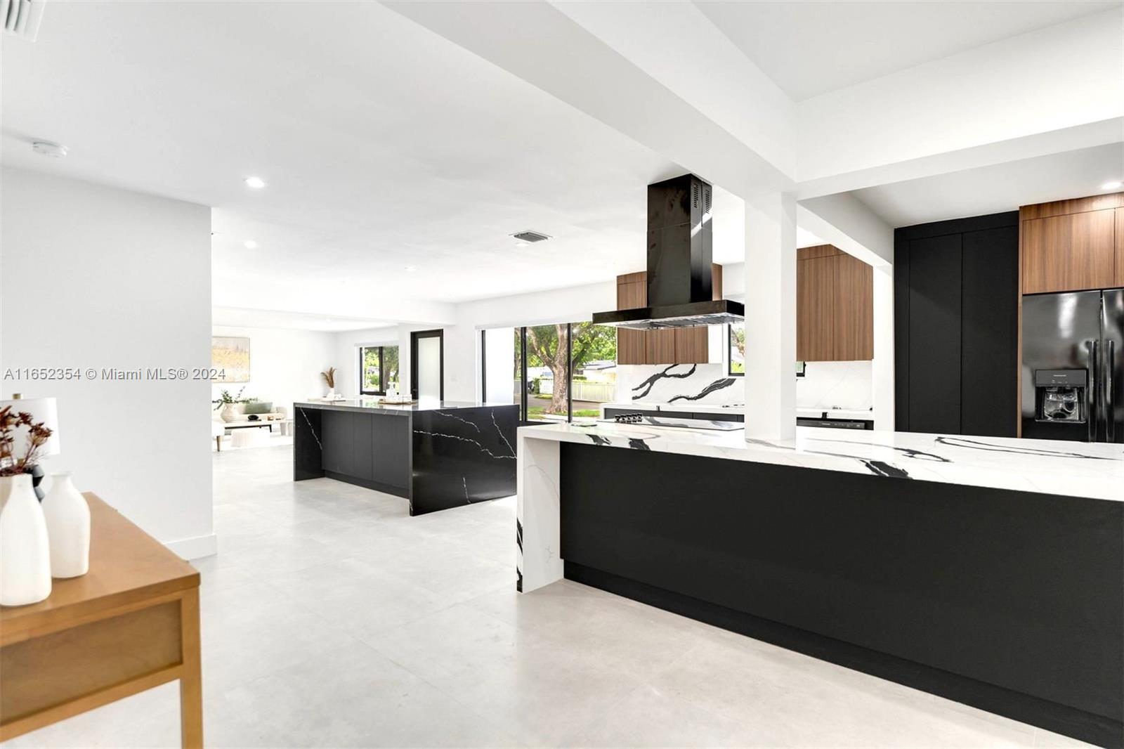 a large kitchen with kitchen island a sink stainless steel appliances and cabinets