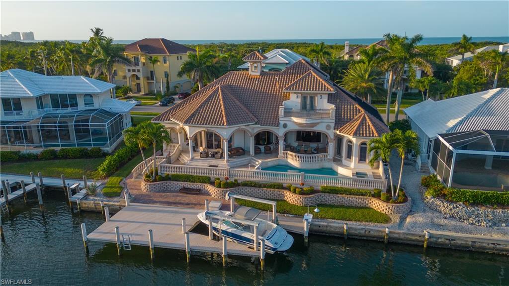 a aerial view of a house with swimming pool lawn chairs and a yard