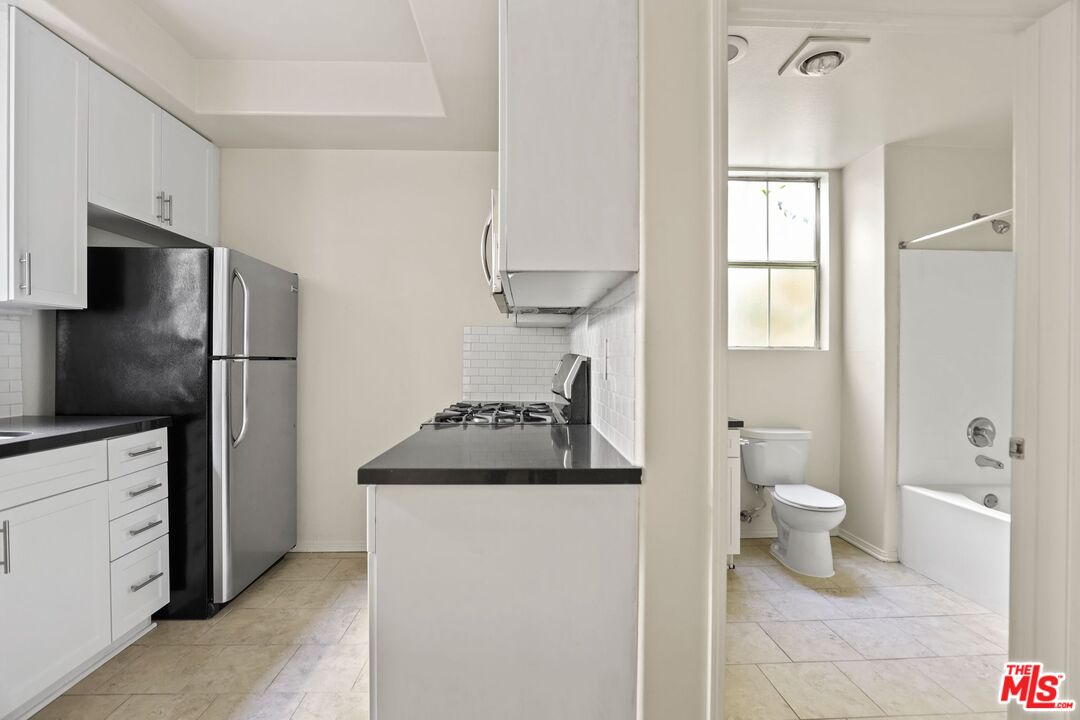 a kitchen with stainless steel appliances a refrigerator and a stove