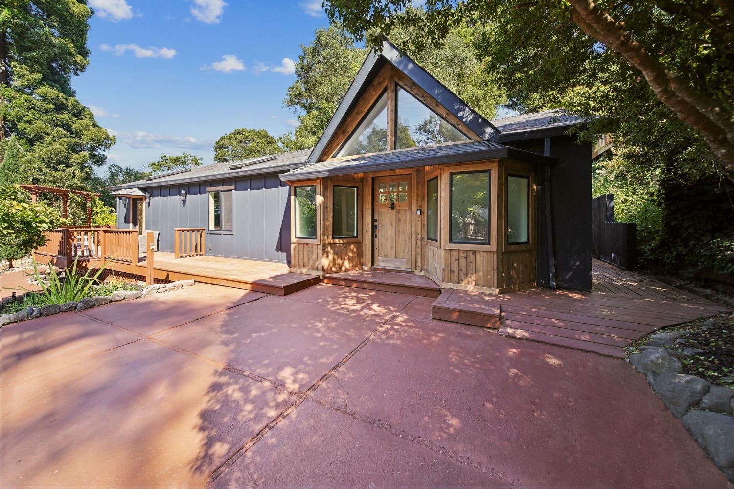 a front view of a house with basket ball court and outdoor seating