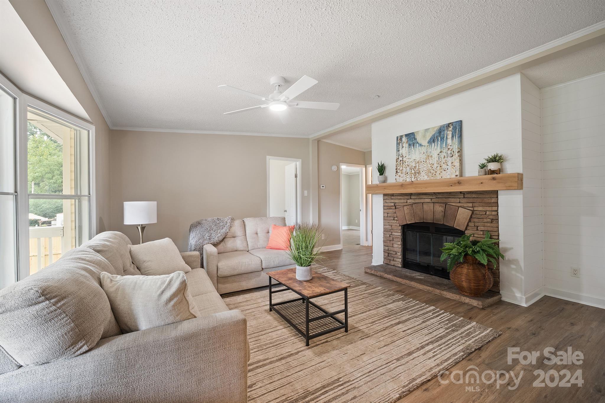 a living room with furniture and a fireplace