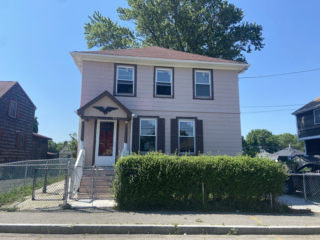 a view of a brick house with a yard