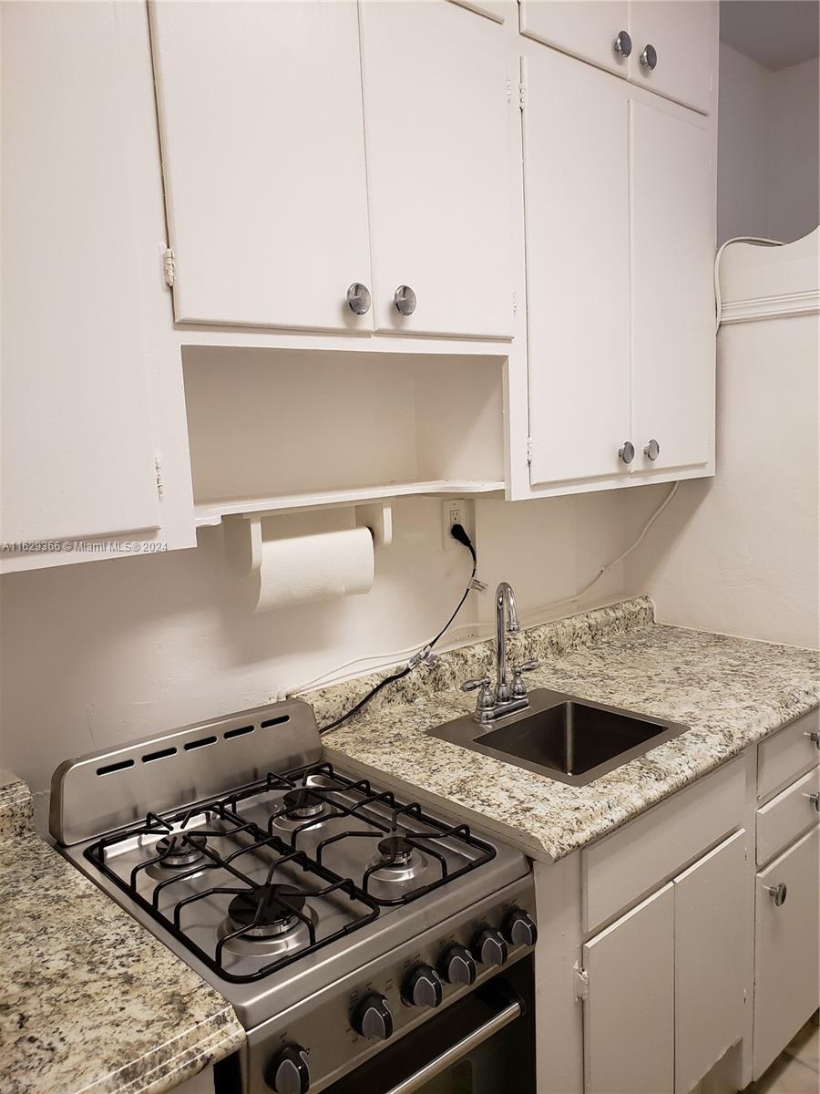 a white stove top oven sitting inside of a kitchen