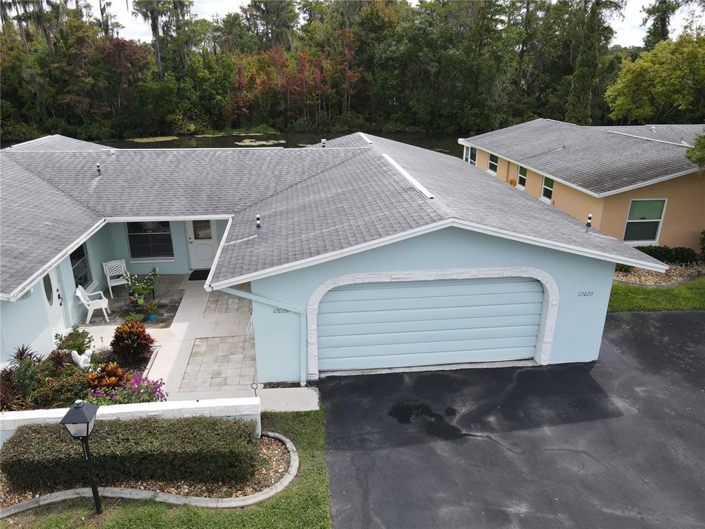 a aerial view of a house with a yard and garage