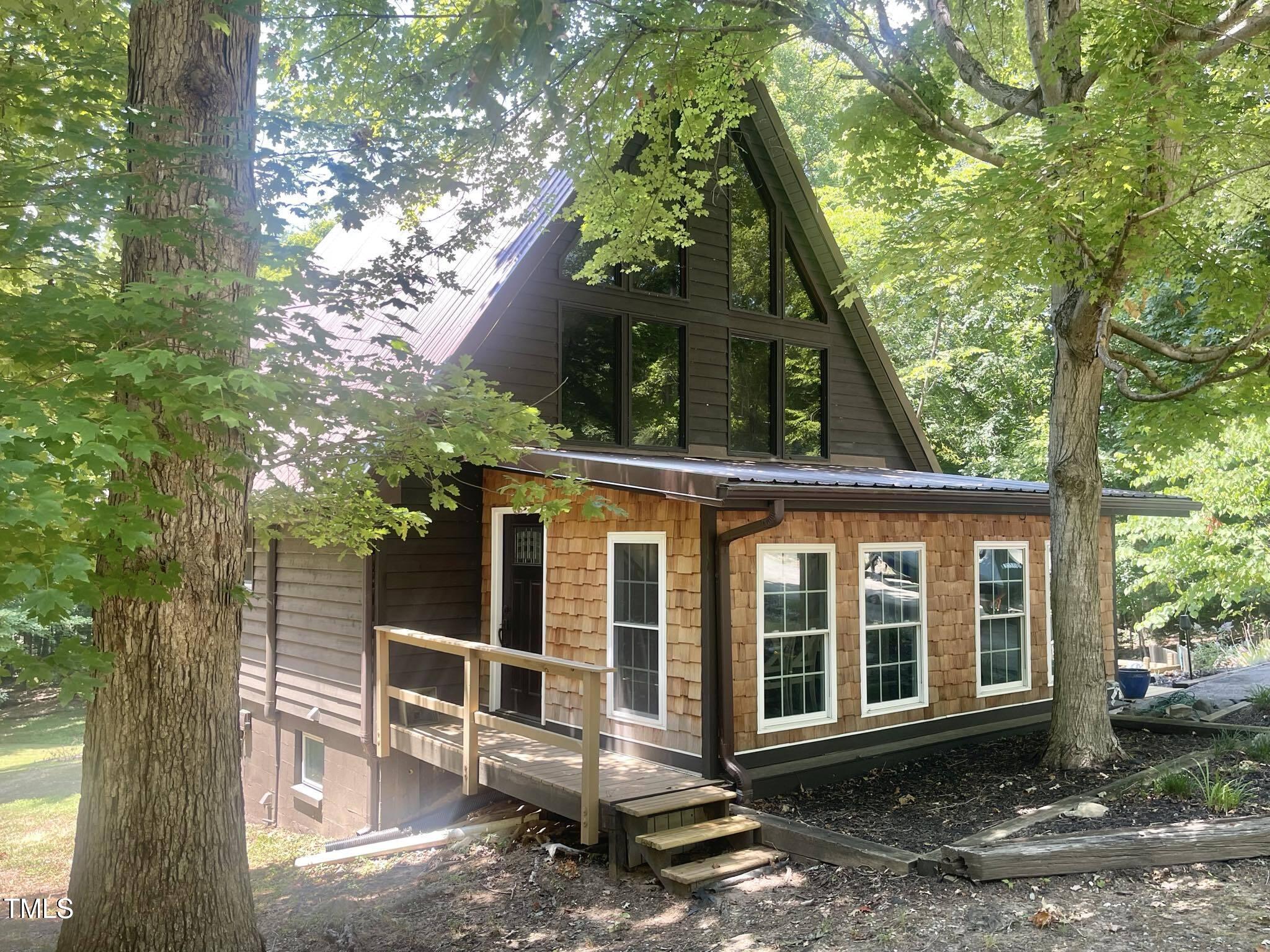 front view of a house with a tree