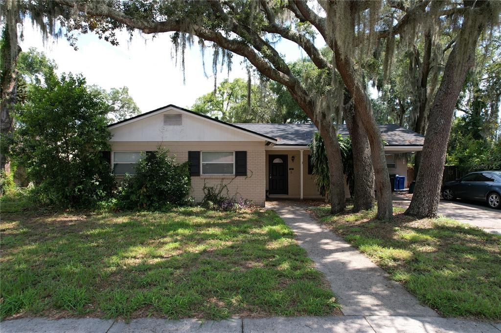 a front view of a house with a garden