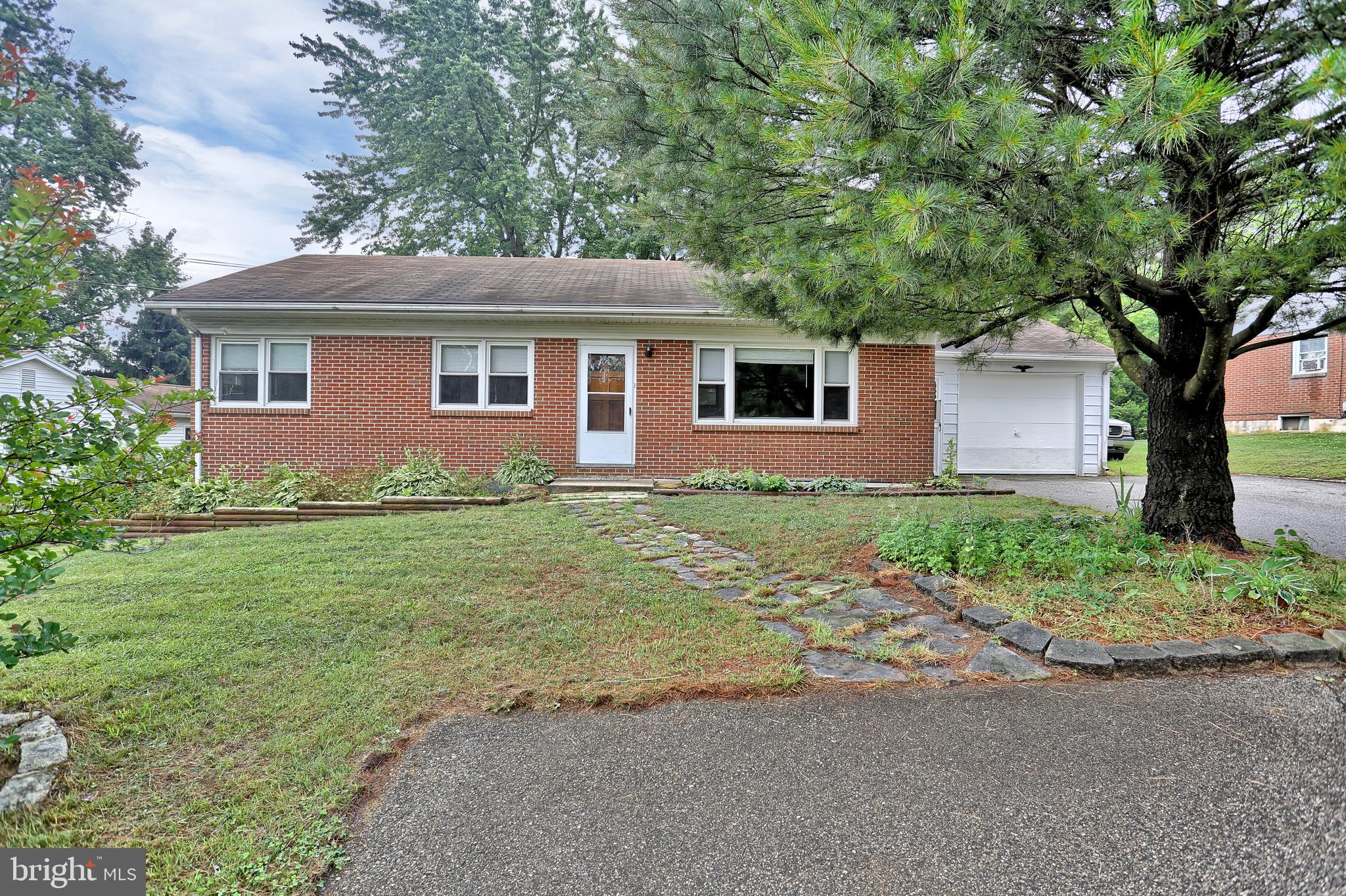 a front view of house with yard and trees