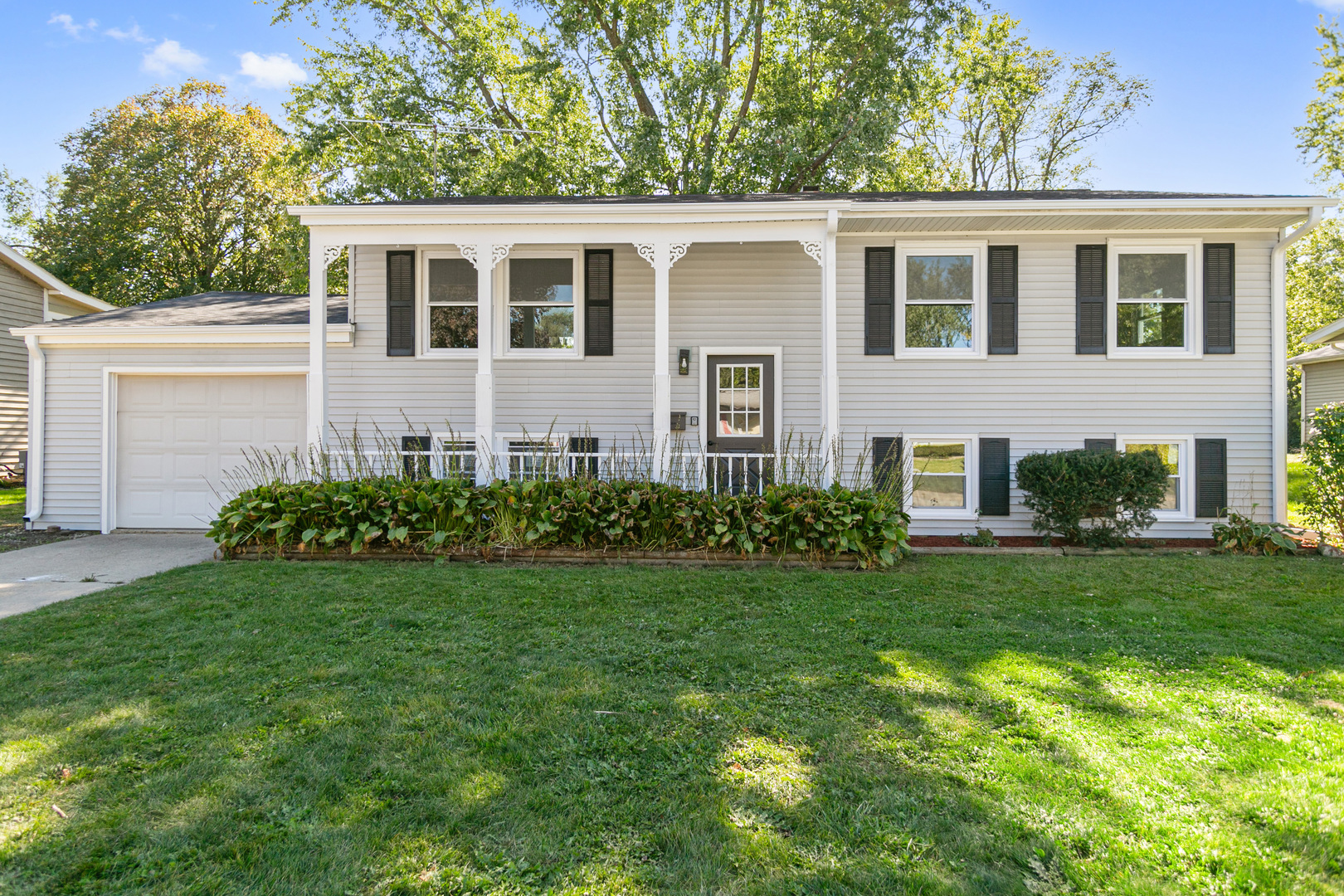 a front view of a house with a garden