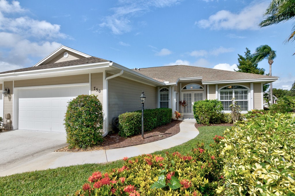 a front view of a house with garden