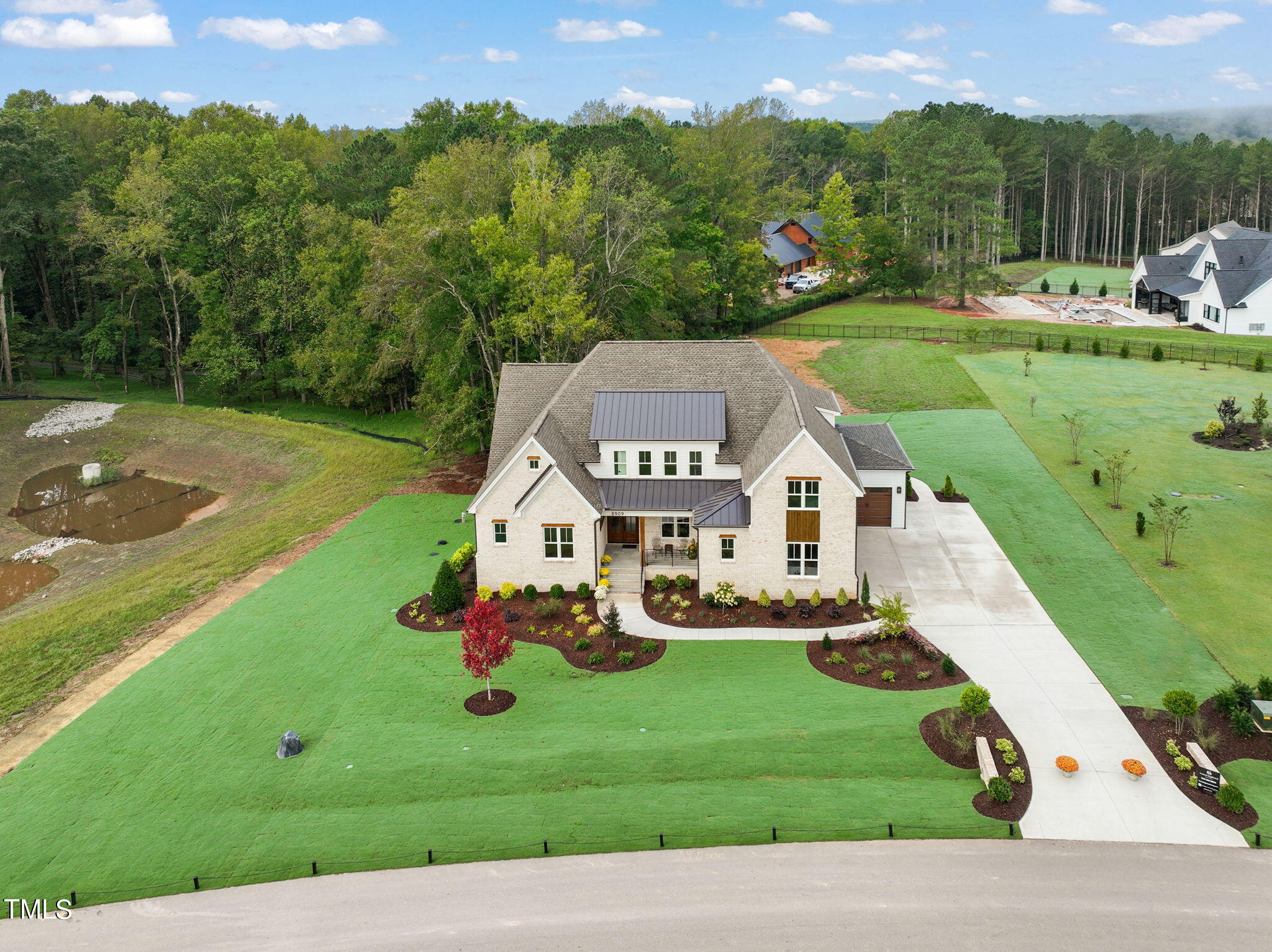 an aerial view of a house with a big yard