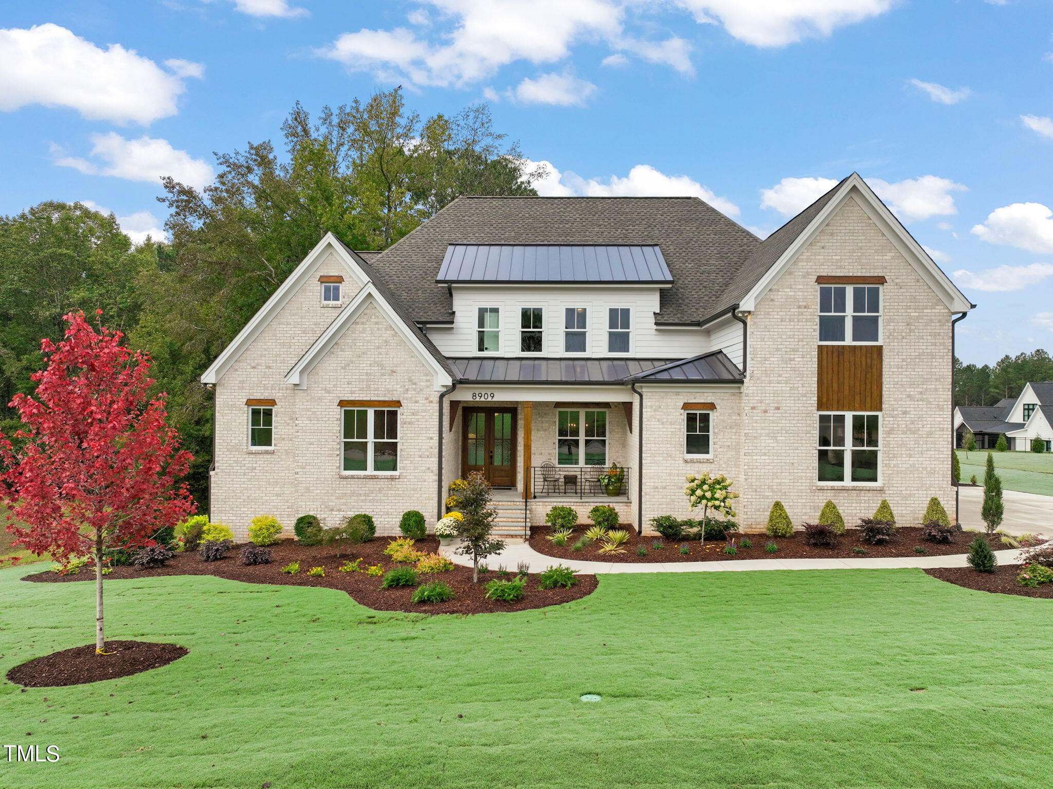 a front view of house with yard and green space