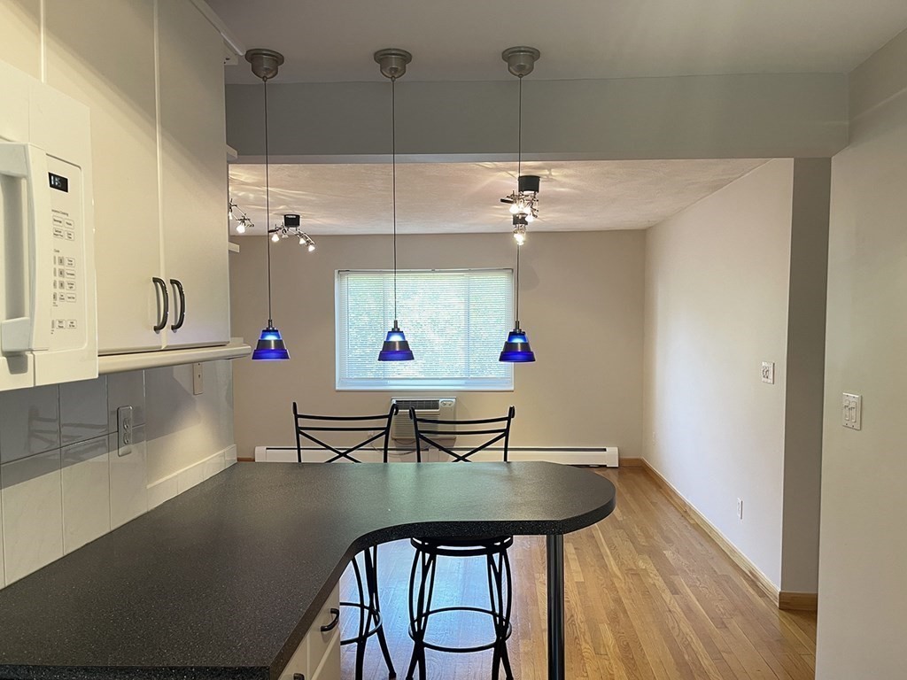 a view of dining table chairs and window