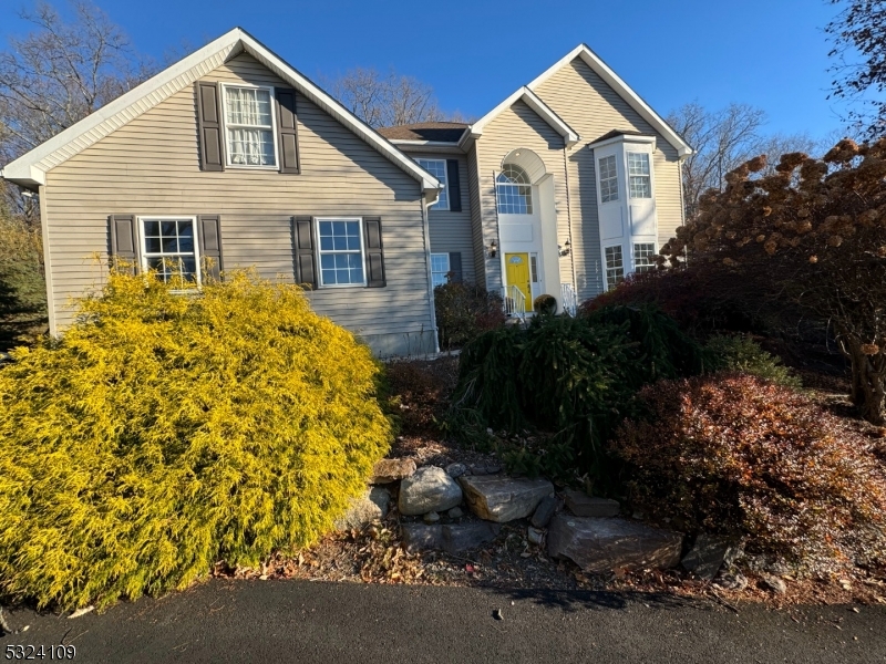 a view of a house with a yard and plants