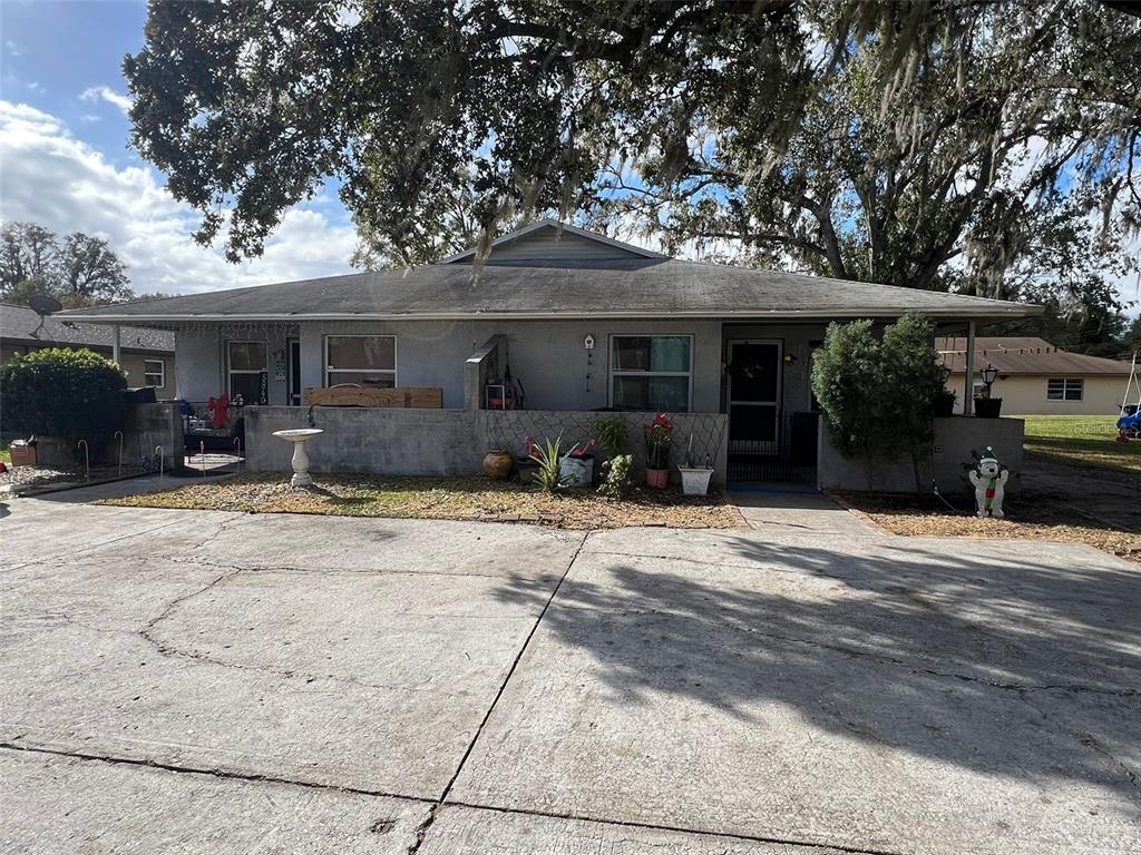 a front view of a house with a yard and a garage