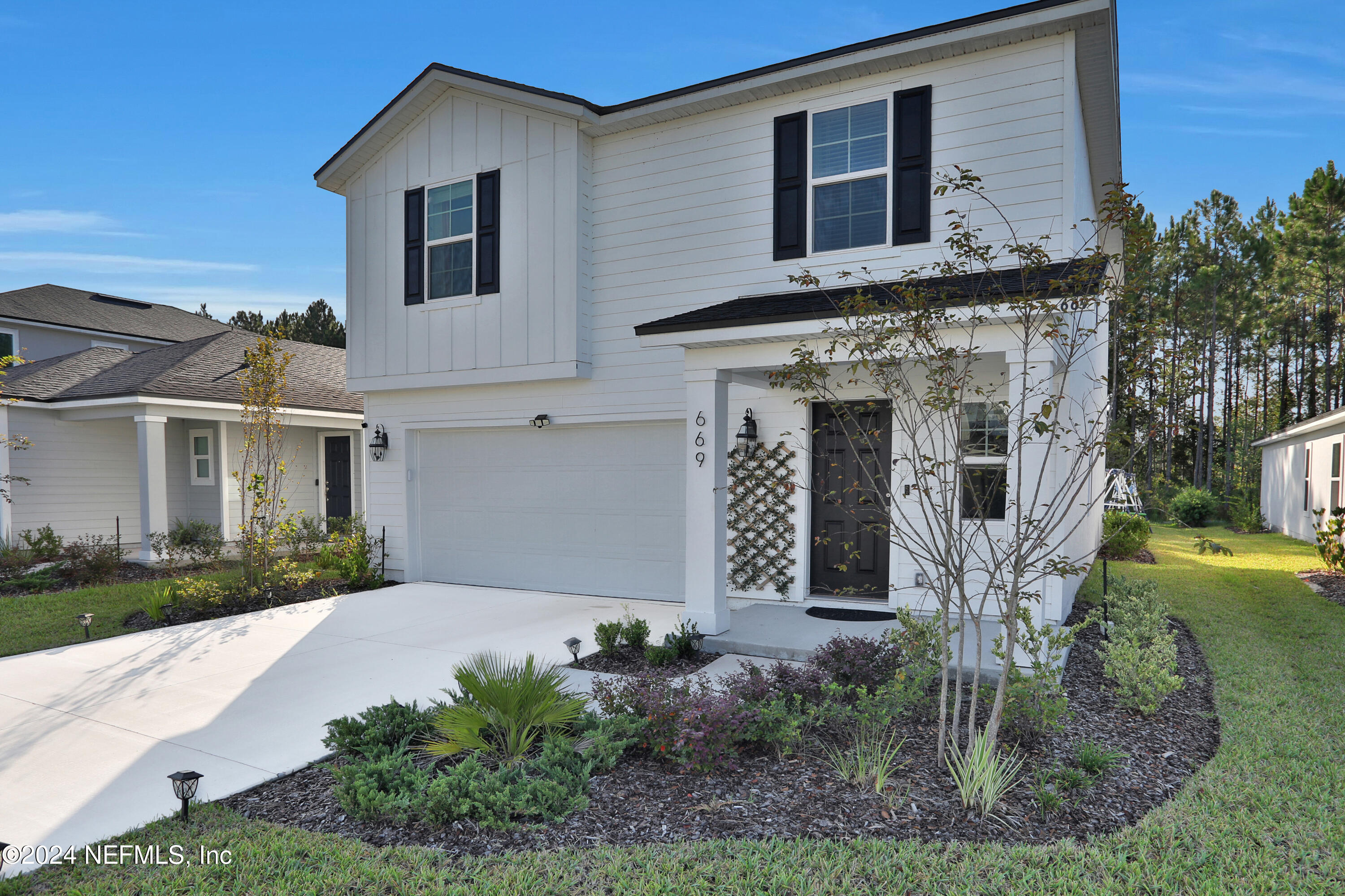 a front view of a house with garden