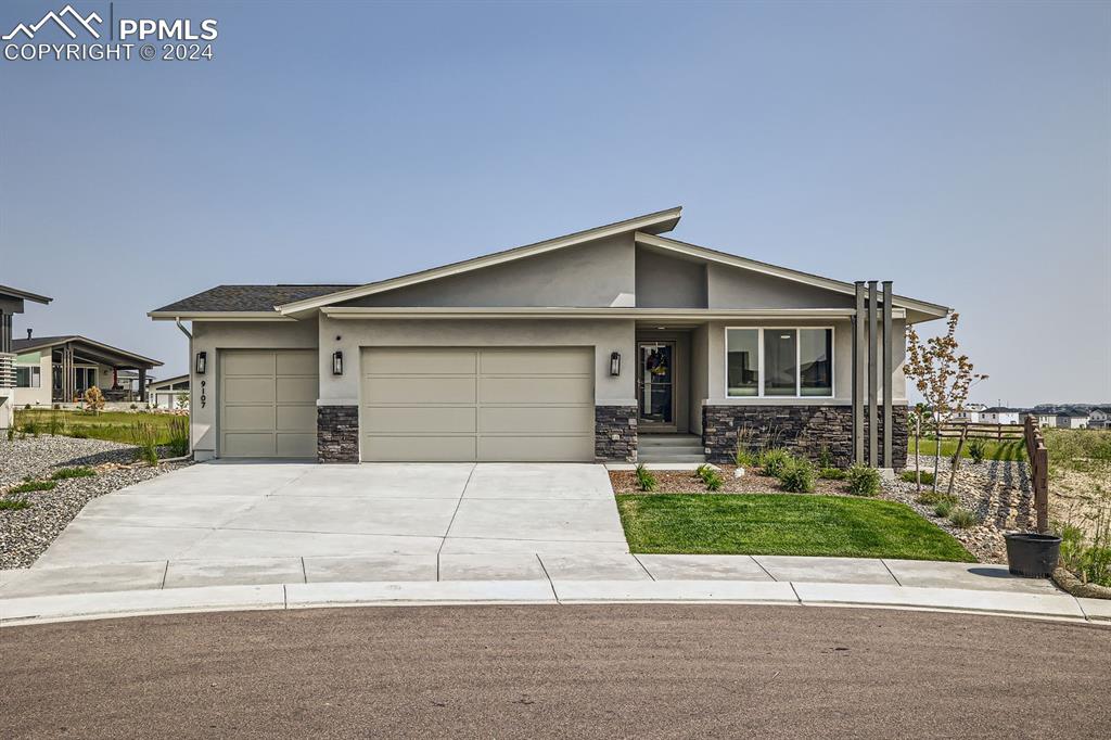 a front view of a house with a yard and garage