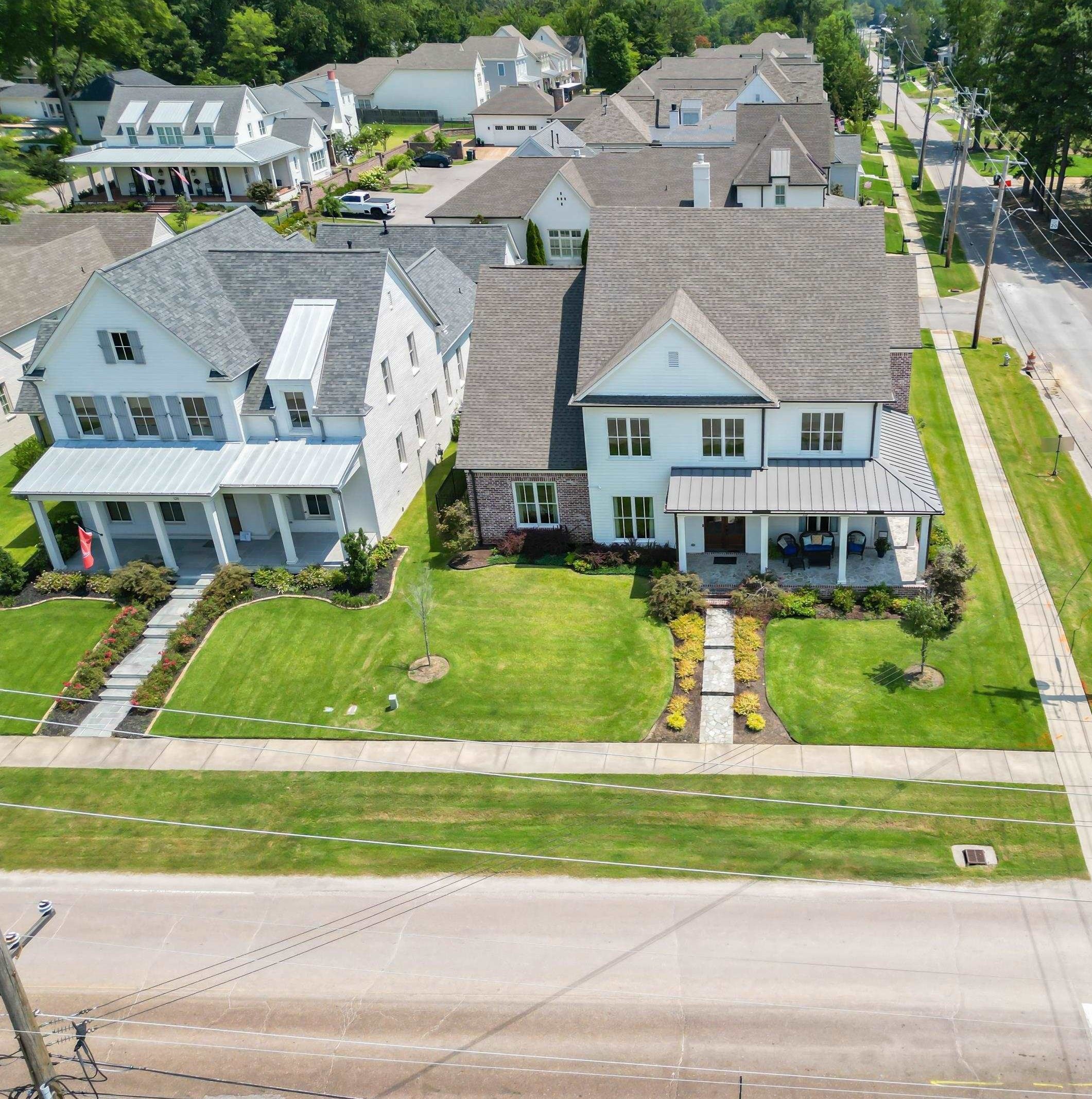 a view of houses with yard and swimming pool