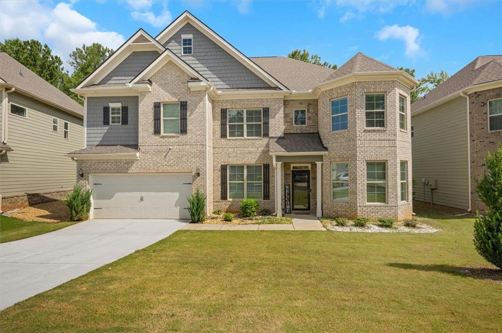 a front view of a house with a yard