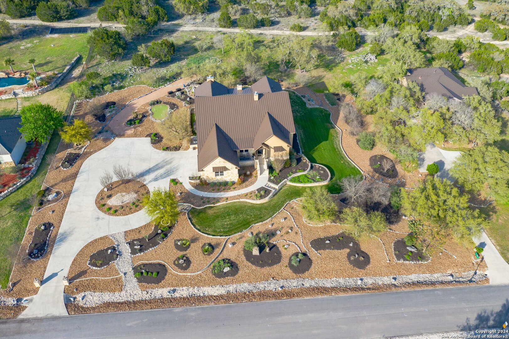 an aerial view of a house with garden space and street view