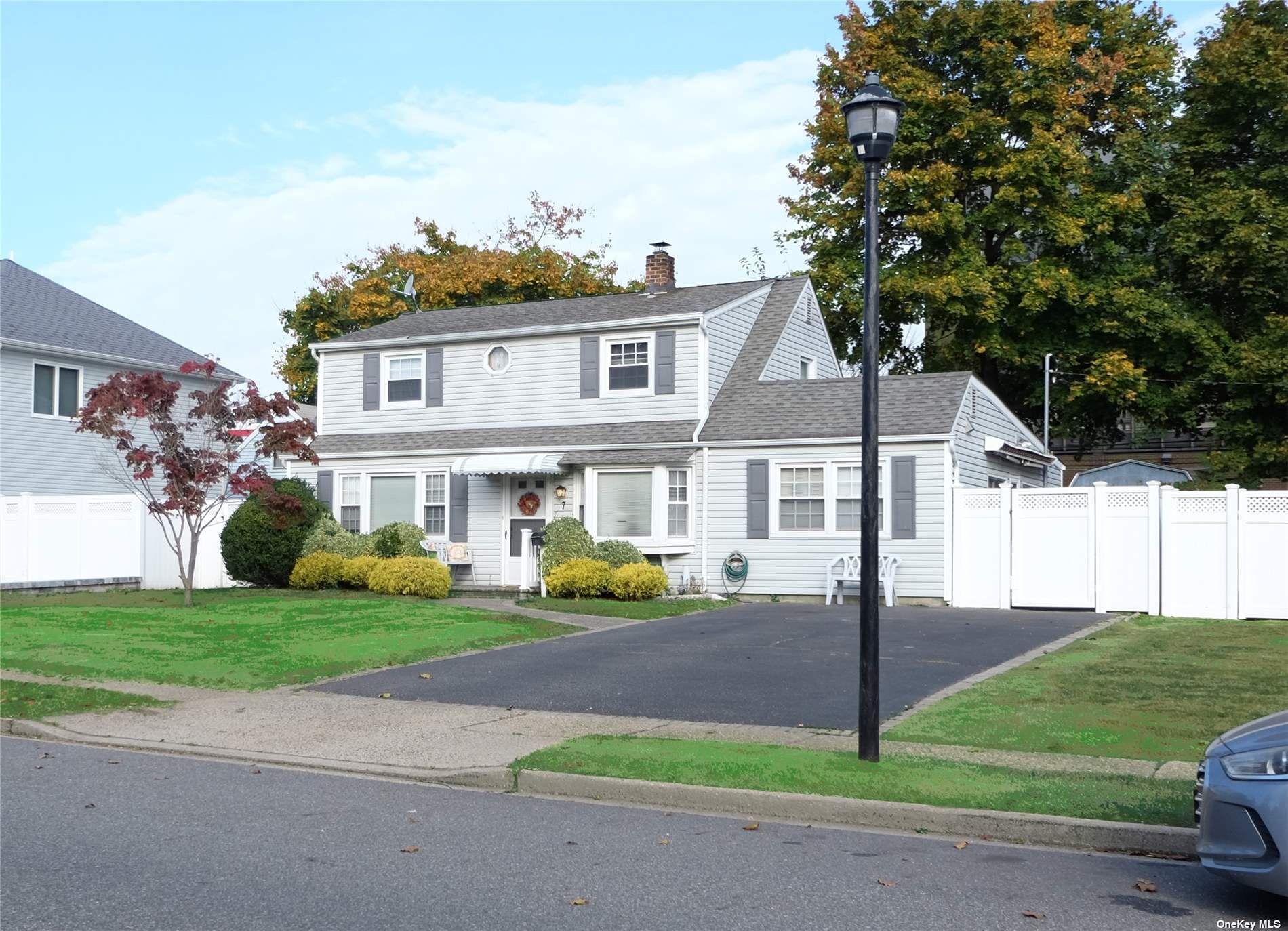 a front view of a house with a garden and plants