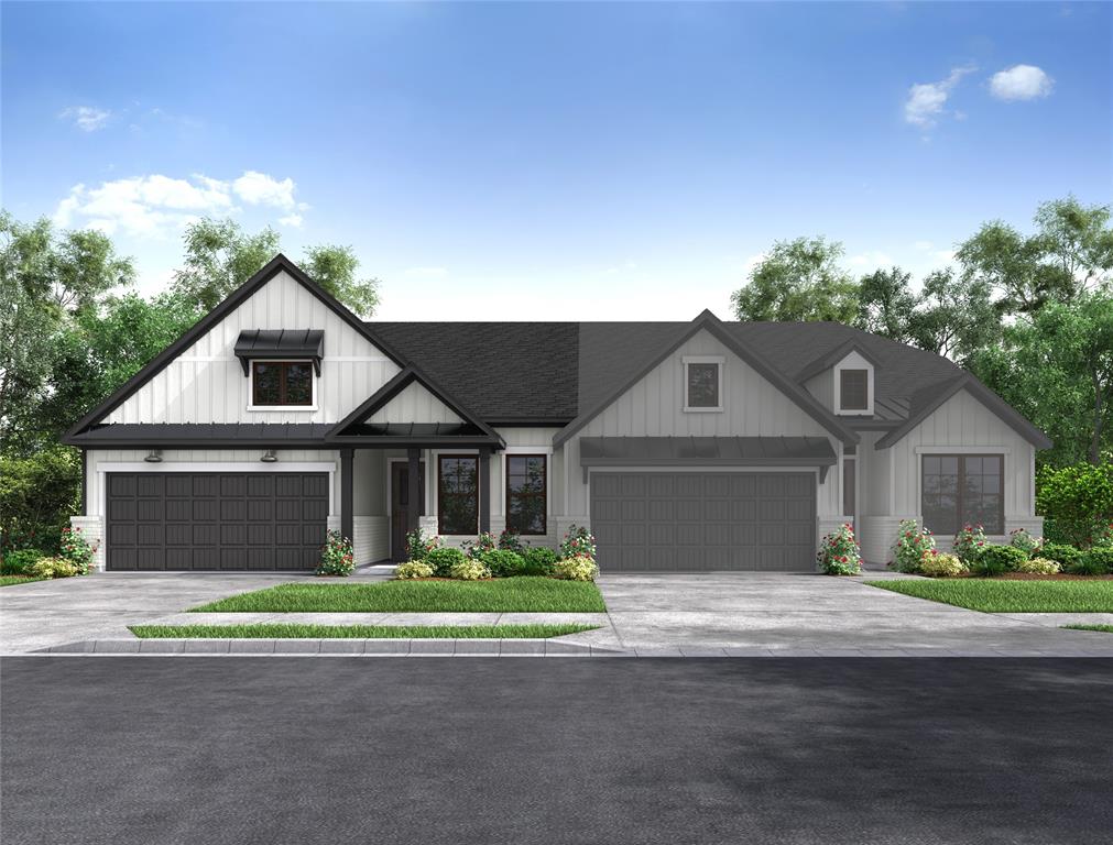 a front view of a house with a garden and garage