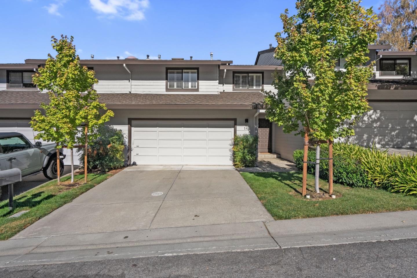 a front view of a house with a yard and a garage