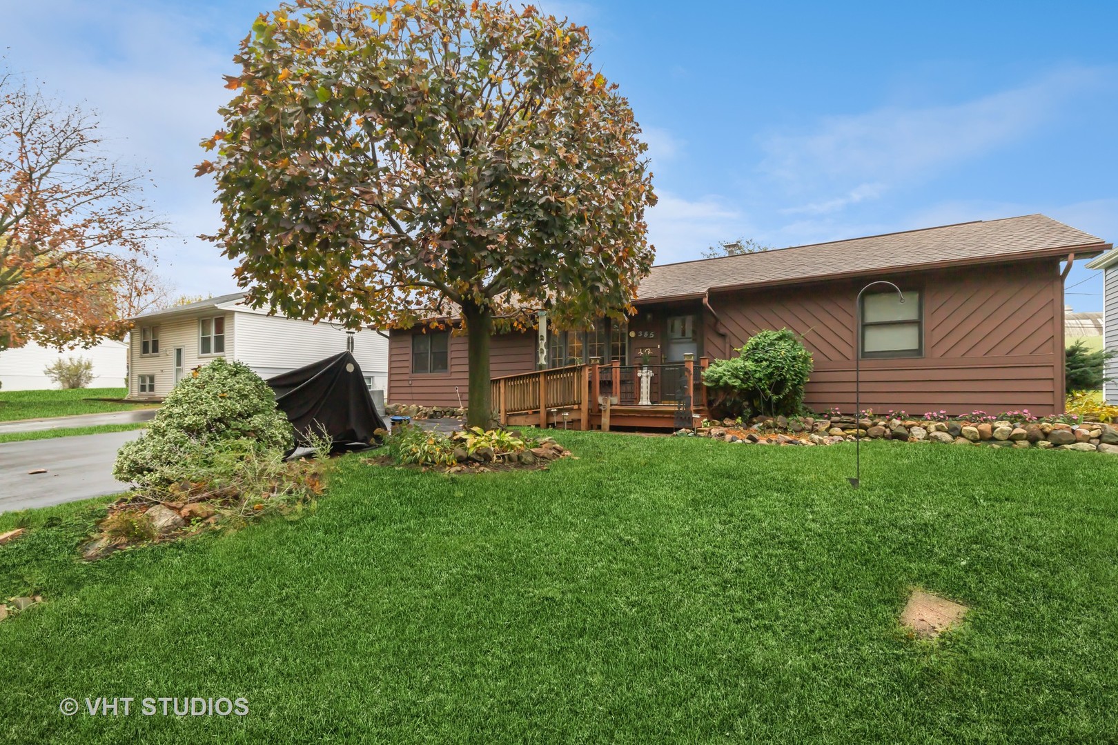 a view of backyard of house with green space