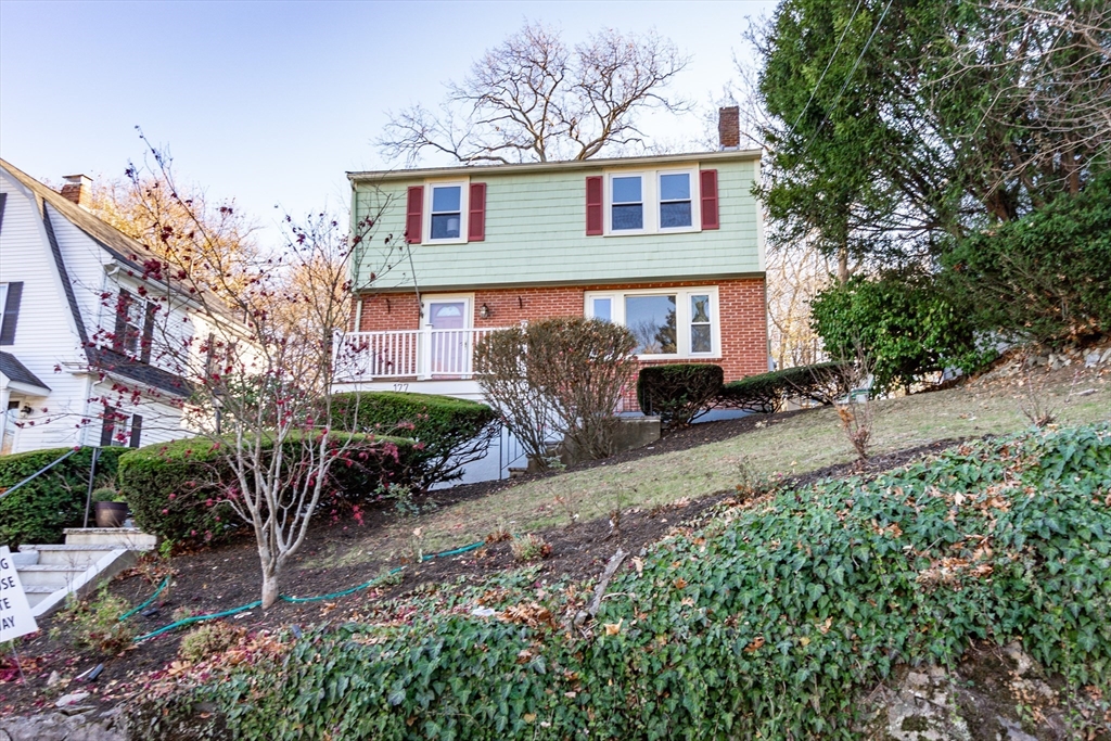 a front view of a house with garden