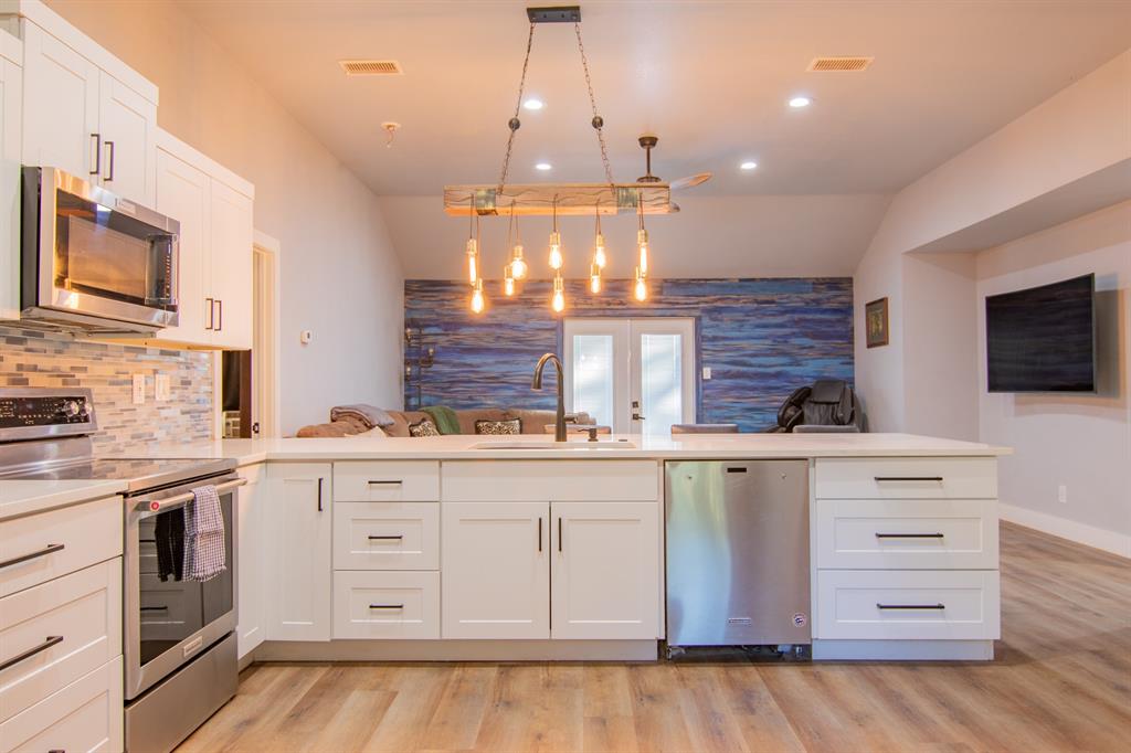 a kitchen with stainless steel appliances granite countertop a stove and a sink