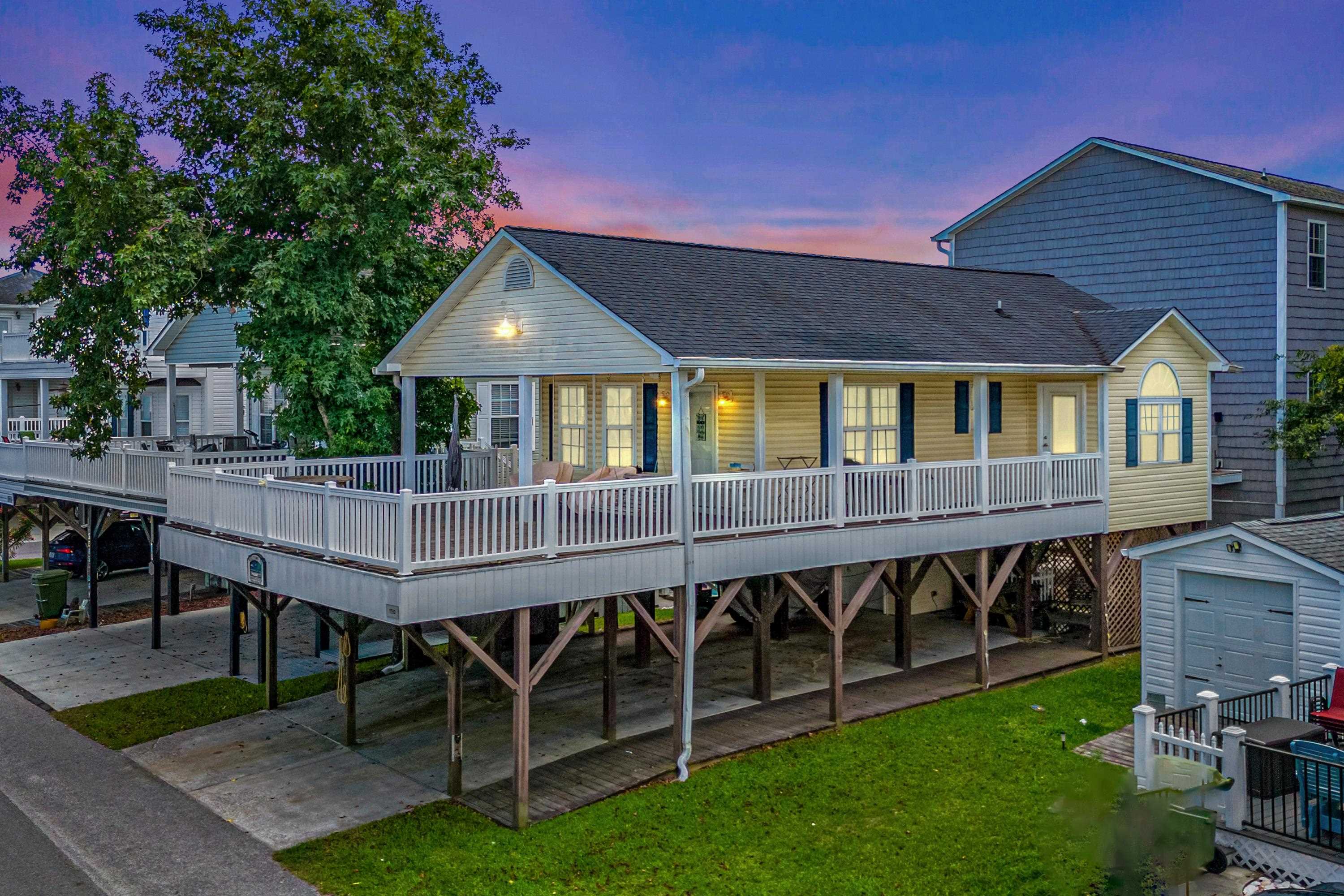 Exterior space with a carport, a yard, and a garag