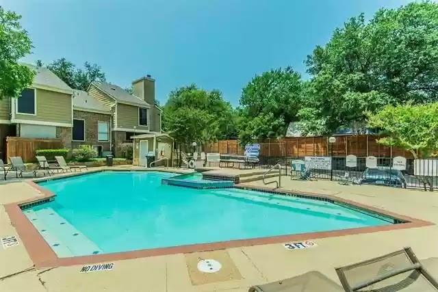 a view of a house with swimming pool and sitting area