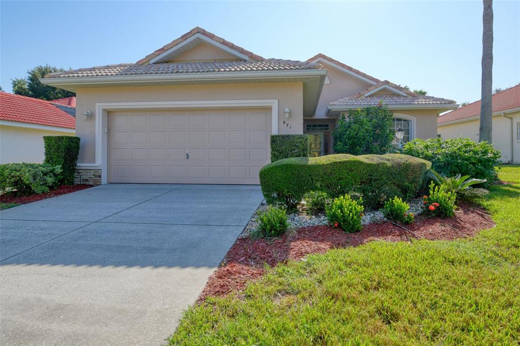 a front view of a house with a yard and garage