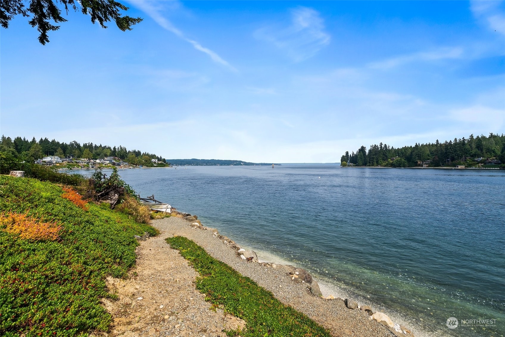 a view of a lake with beach and city view