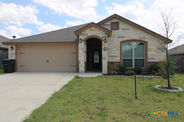 a front view of a house with a yard