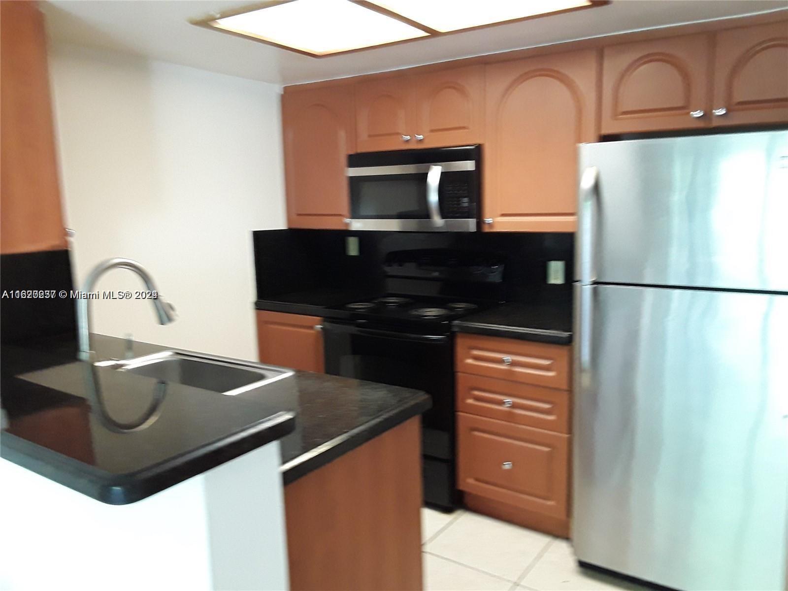 a kitchen with a sink and a refrigerator