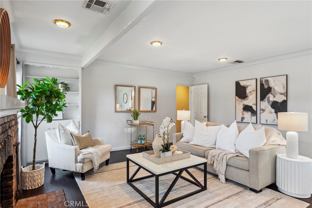 a living room with furniture and a potted plant