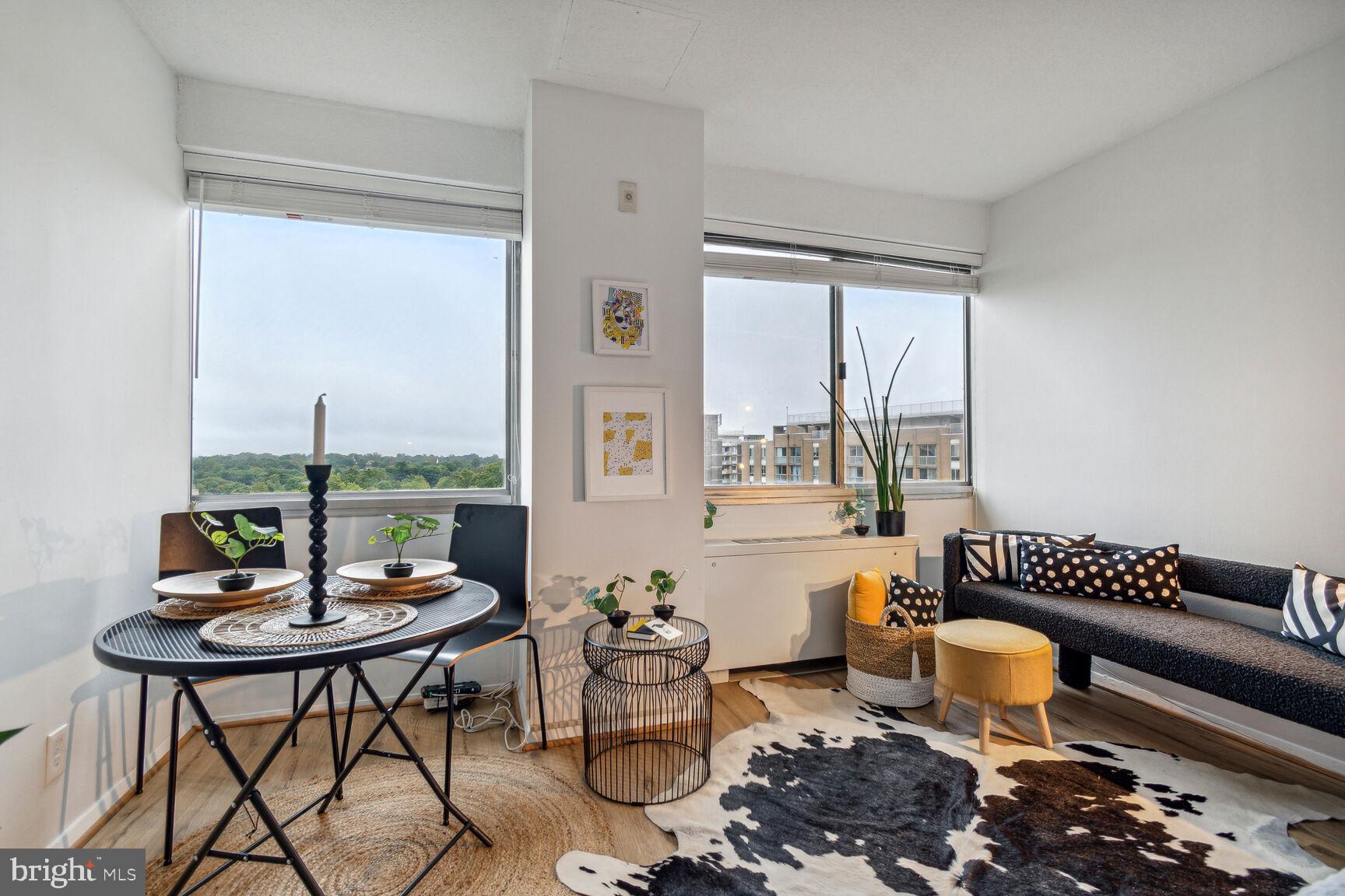 a living room with furniture and floor to ceiling window