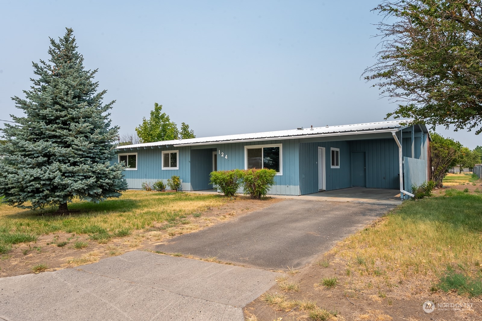 a front view of a house with a garden and patio