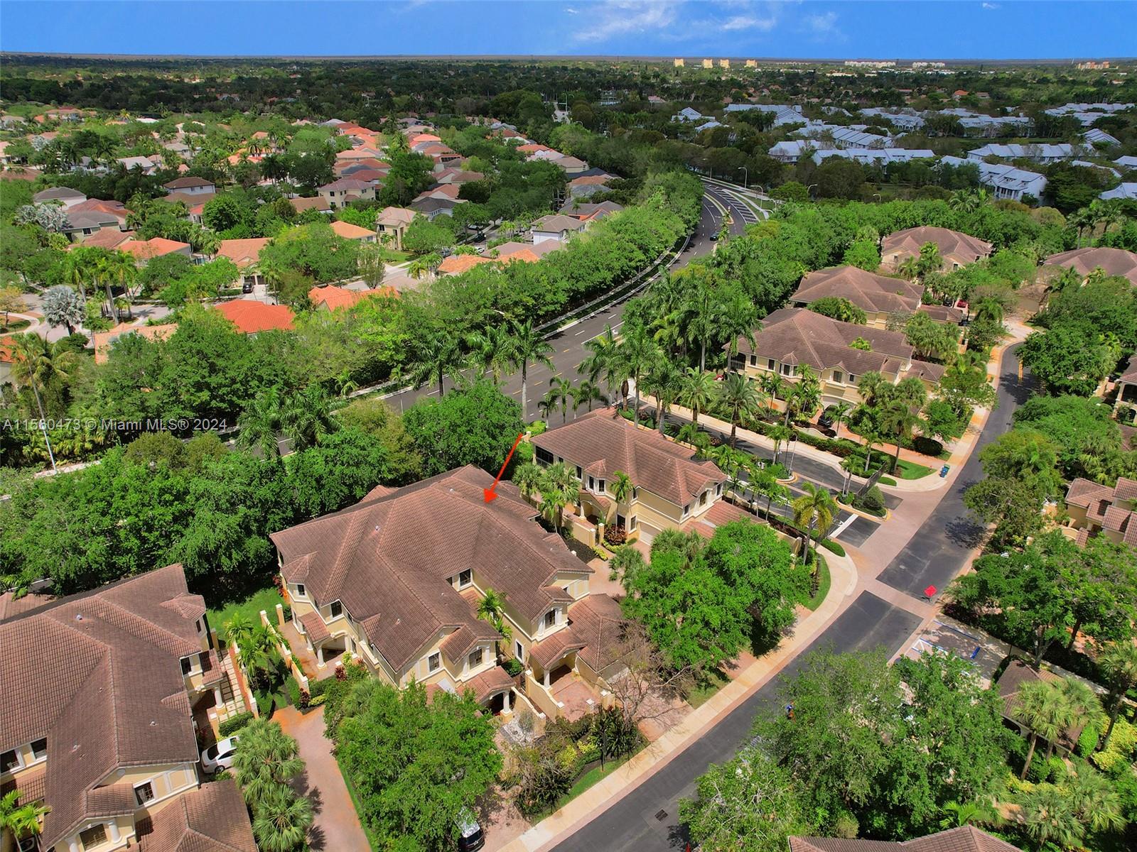 an aerial view of residential houses with outdoor space and trees