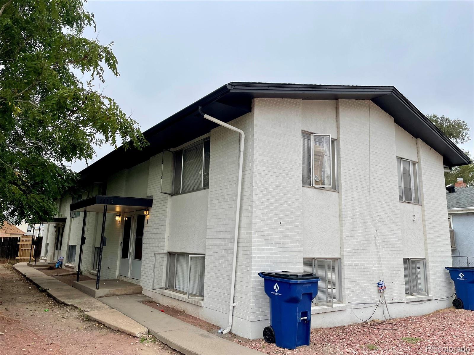 a front view of a house with parking space