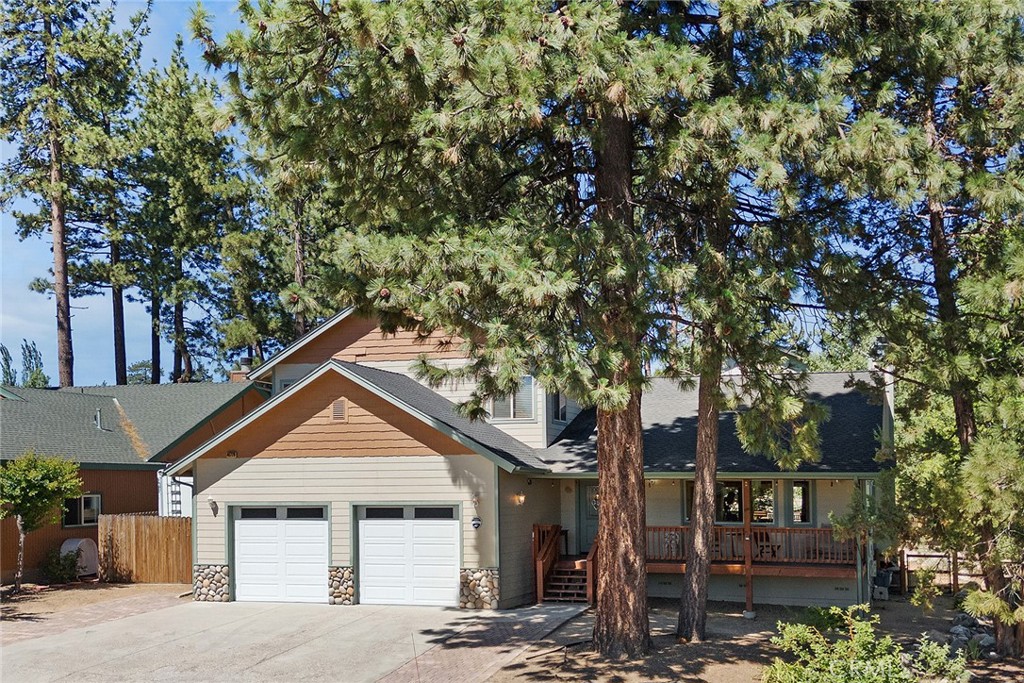 front view of a house with a tree