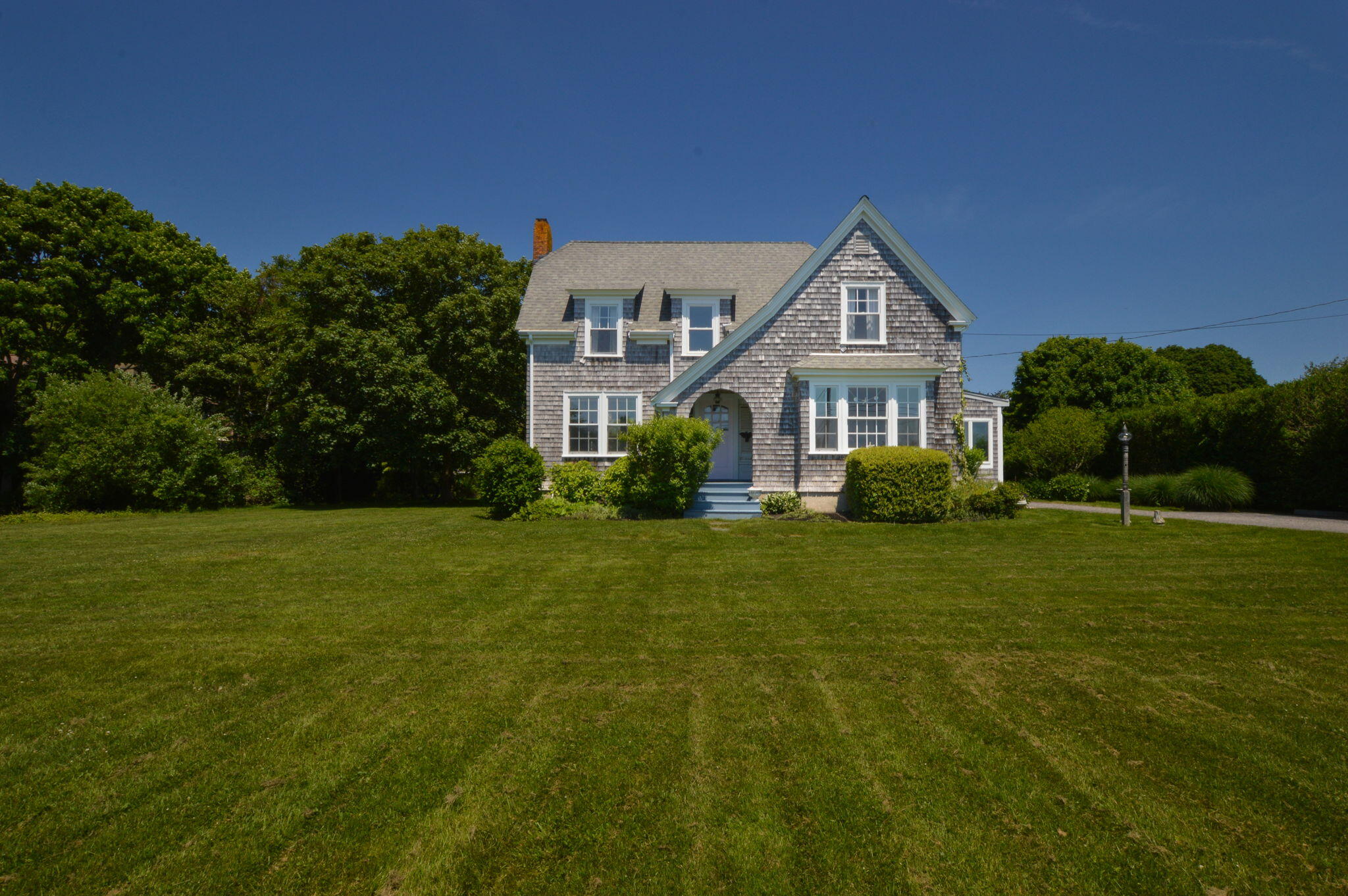 a front view of a house with a garden