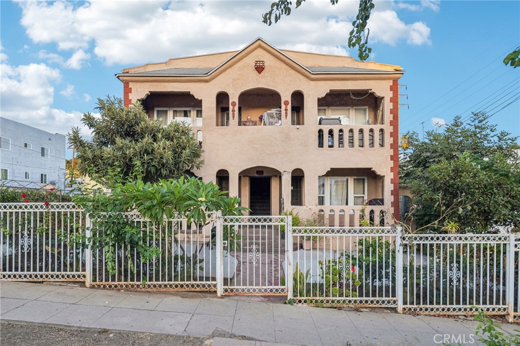 a front view of a house with a fence