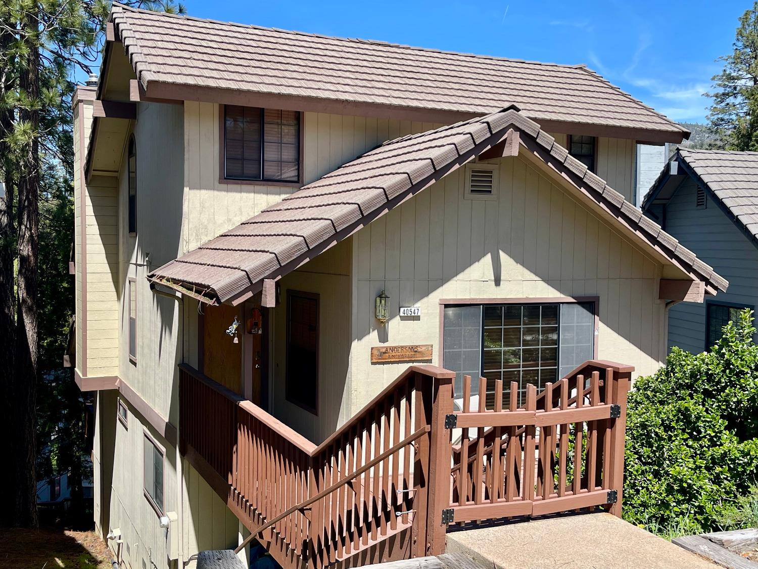 a front view of house along with deck and furniture