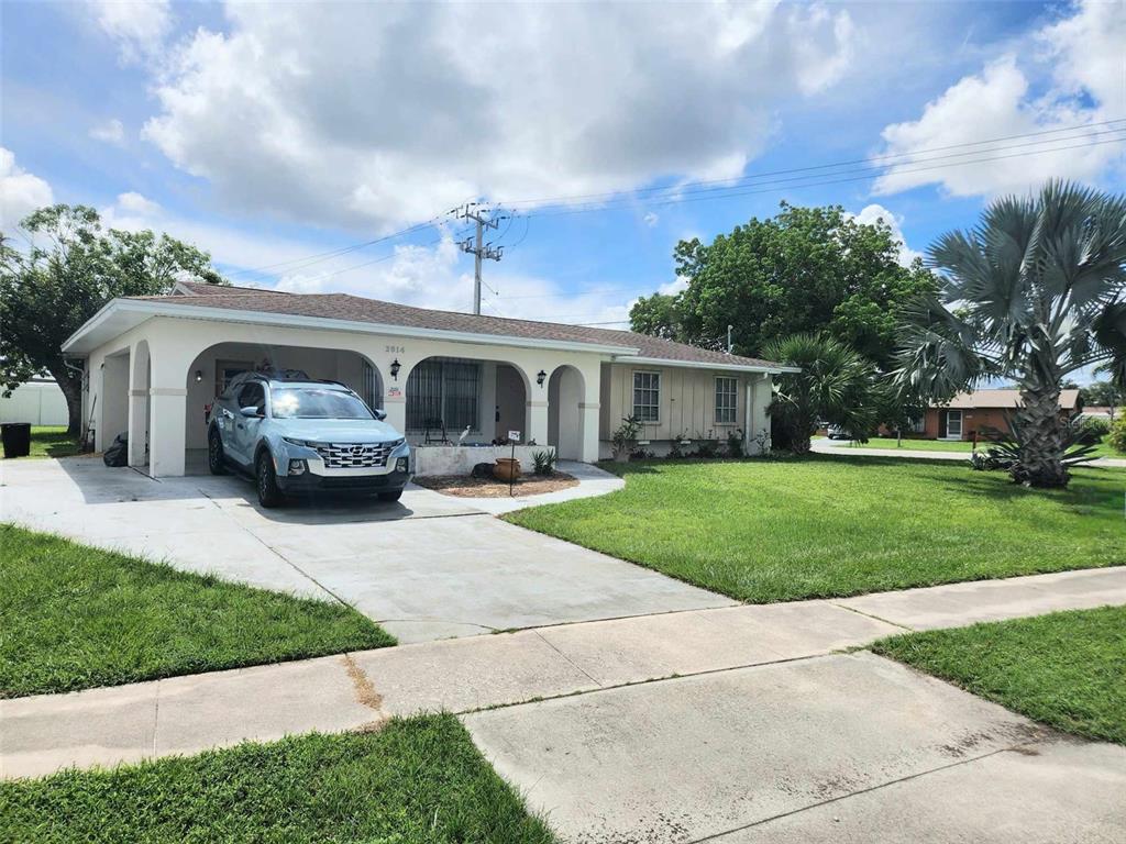 a front view of house with yard and green space