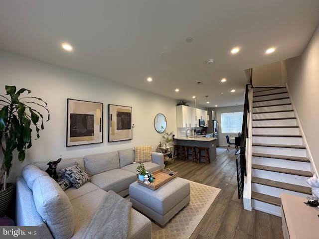 a living room with furniture and a wooden floor