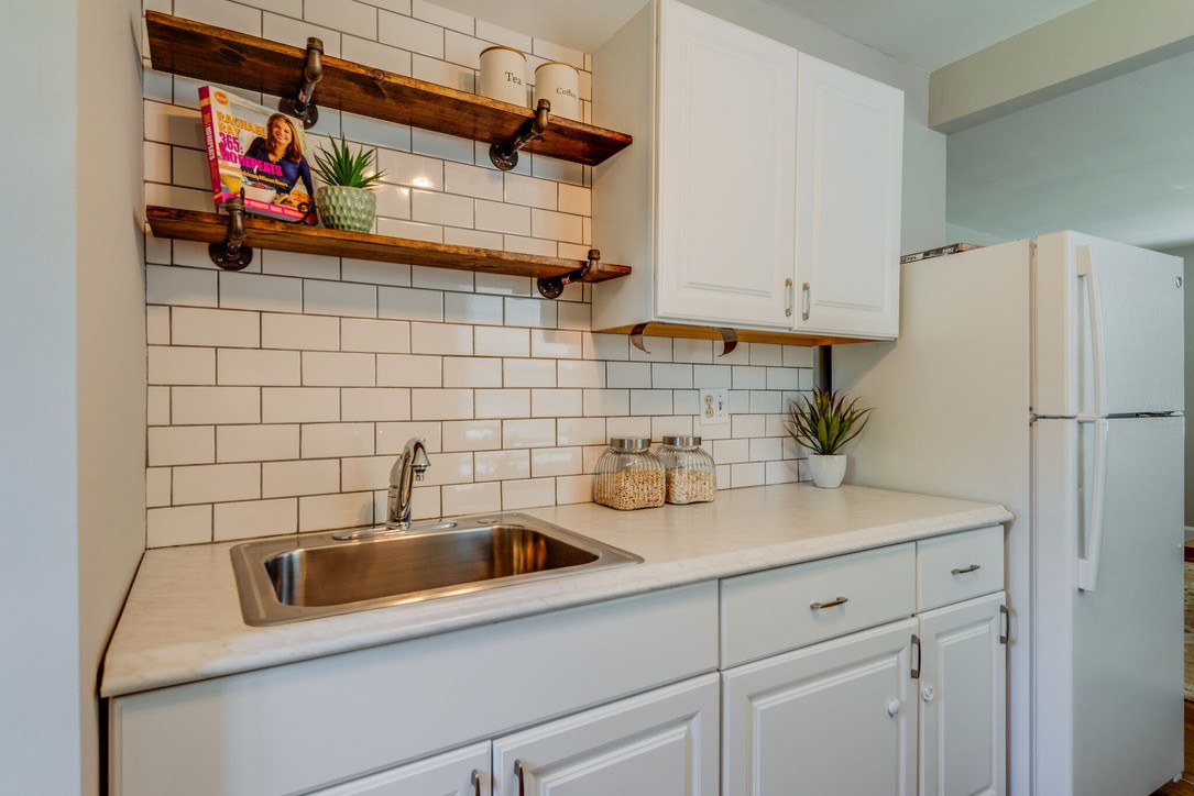 a view of a storage and utility room with a sink